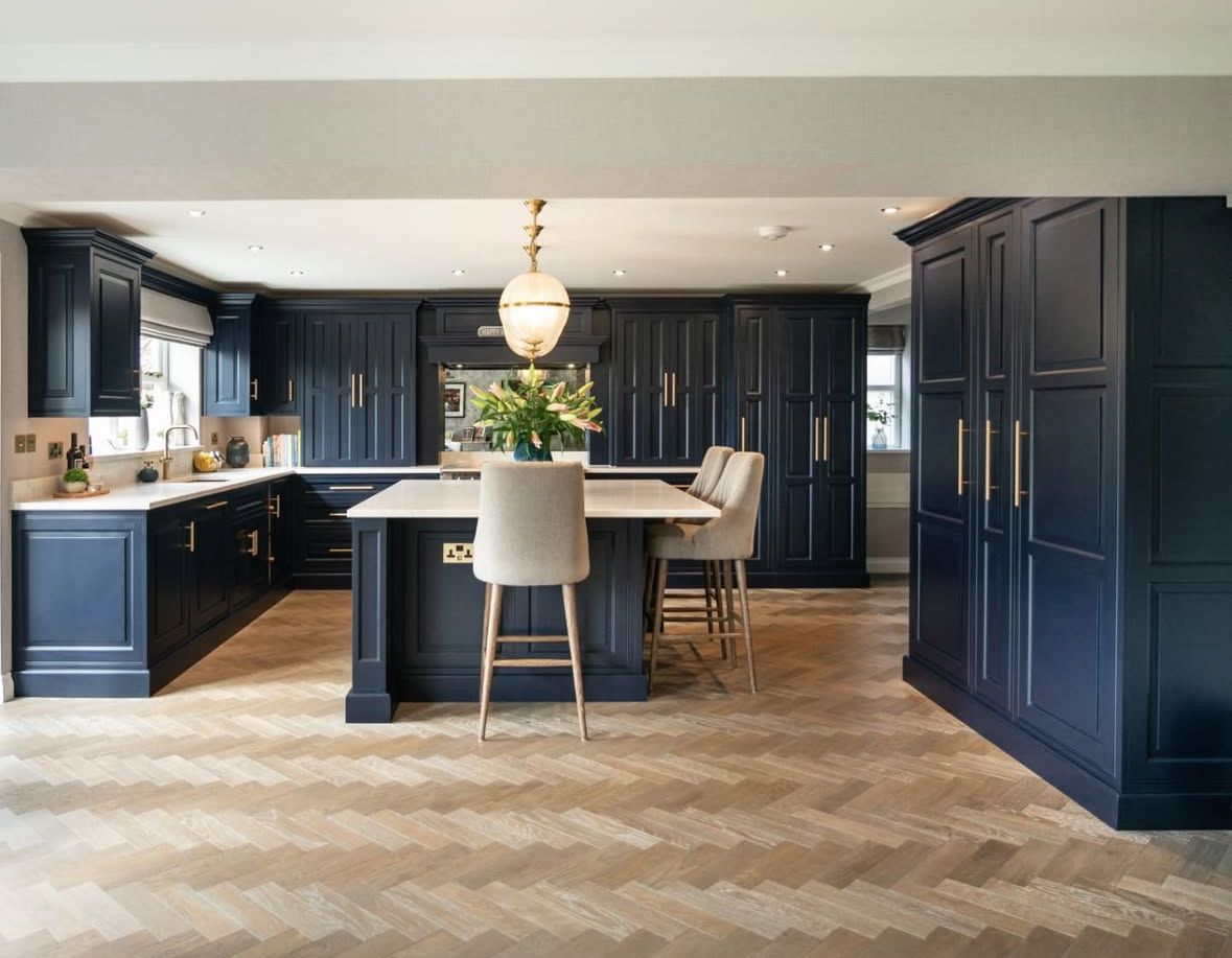 Navy shaker kitchen installation in Hertford with brass handles and island